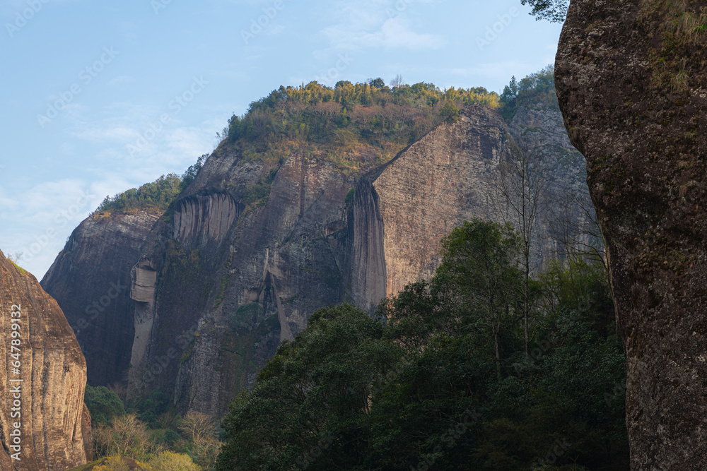 Close up on a rocky cliff and the mountains and hills of Wuyishan