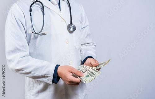 Medical corruption concept. Corrupt doctor counting money isolated, hands of corrupt doctor counting money on isolated background