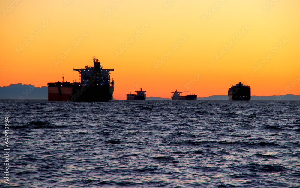 Ships on the  ocean at sunset