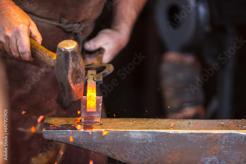 Bilde på lerret Blacksmith forging metal with tools