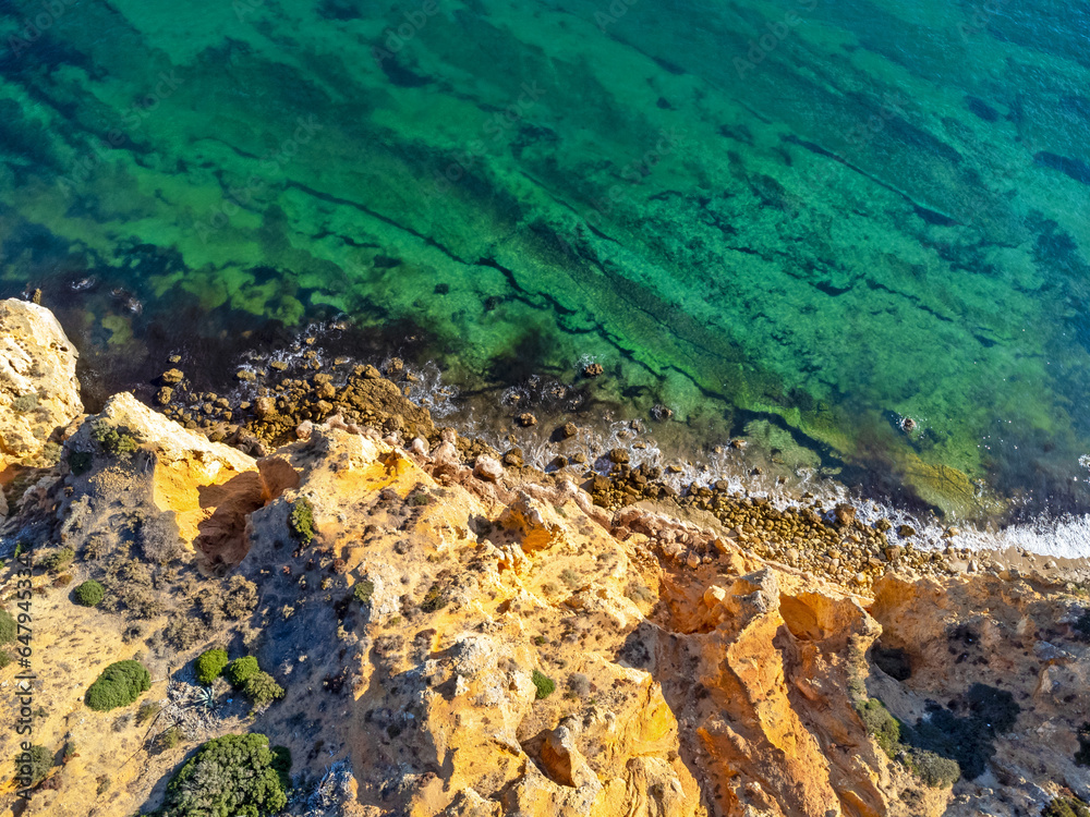 Aerial view landscape, view of an empty, clean, beautiful rocky beach. Photo from a drone. Portugal, Lagos, Algarve region.