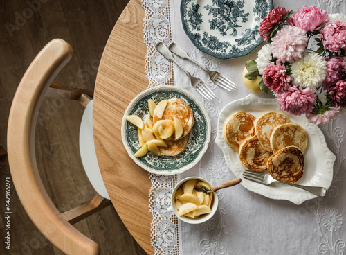Billede på lærred Cozy homemade breakfast - pancakes with apple sauce, vintage dishes, a bouquet o