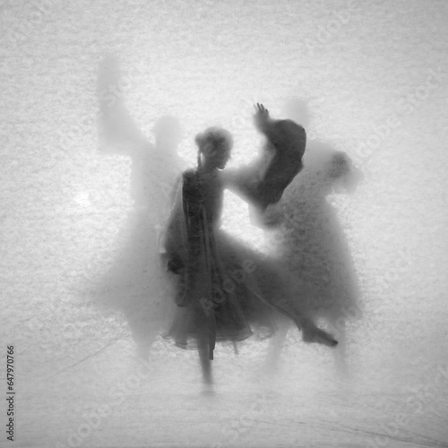 Abstract composition of dancing girls. Theater of shadows through the light with a vintage texture.