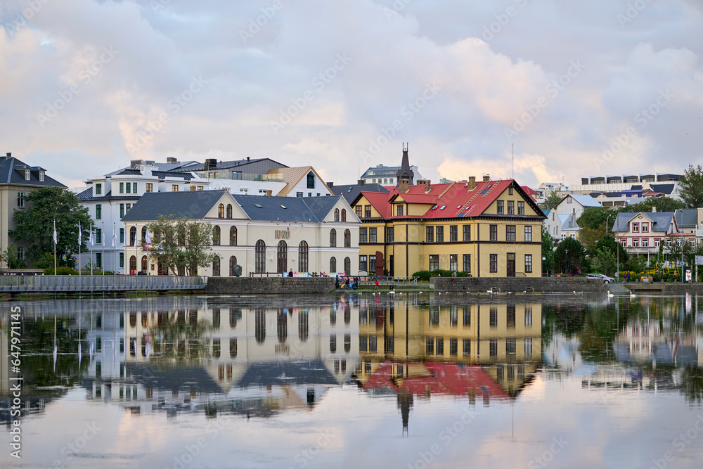 Town lake with colorful buildings on shore