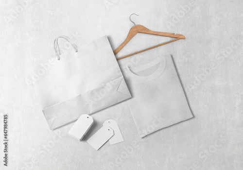 white plain empty black clothing brand branding paper shopping bag t-shirt with wooden hanger and paper hanging tag labels on isolated background