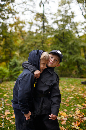 Hello october. Portrait of a cute kids in autumn park. Сhildren having fun outdoors
