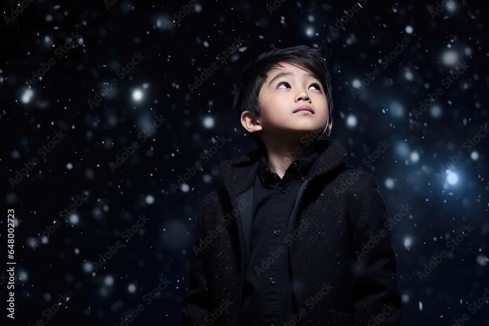 A Young Boy Standing In The Snow Looking Up A Young Boy Standing In The Snow Looking Up