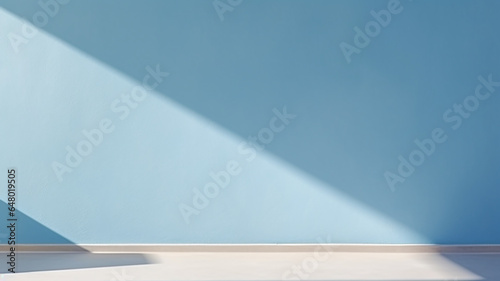light and shadow on light blue wall.