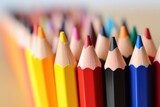 Assorted colored pencils in a row, Colorful pencils on light background, closeup, School supplies.