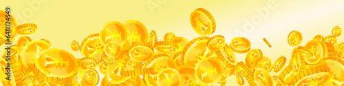 Chinese yuan coins falling. Scattered gold CNY