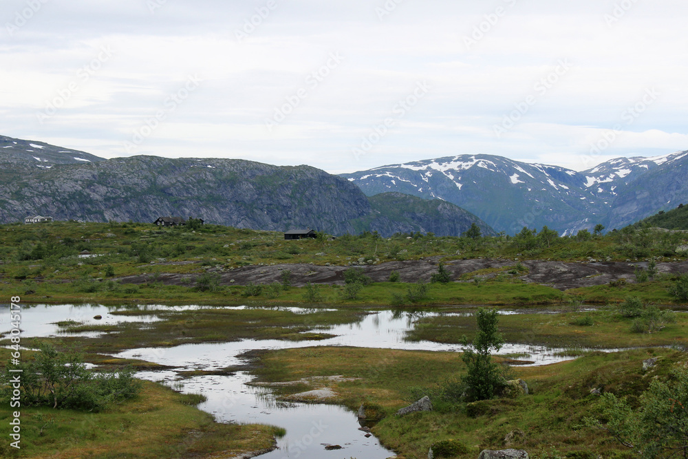 Mountain landscapes of Norway. The top of the mountain range, mountain lake. Hiking to Troltunga