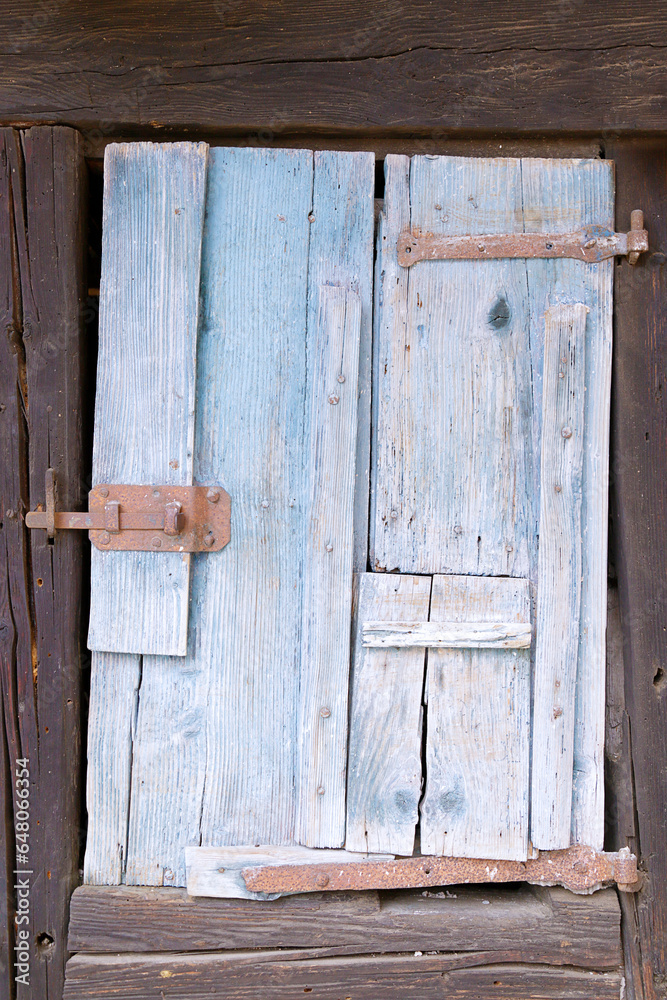 Old rustic wooden window shutter of an old barn. Old rustic wooden window shutter of an old barn.