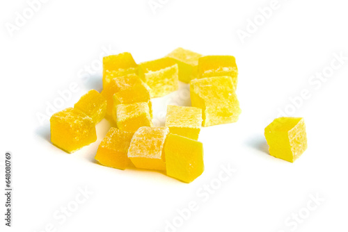 Dried mango cubes isolated on white. Diced mango closeup. Heap of sweetened fruits