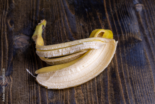 Peeled old ripe banana on the board