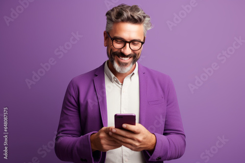 man with phone on purple background.