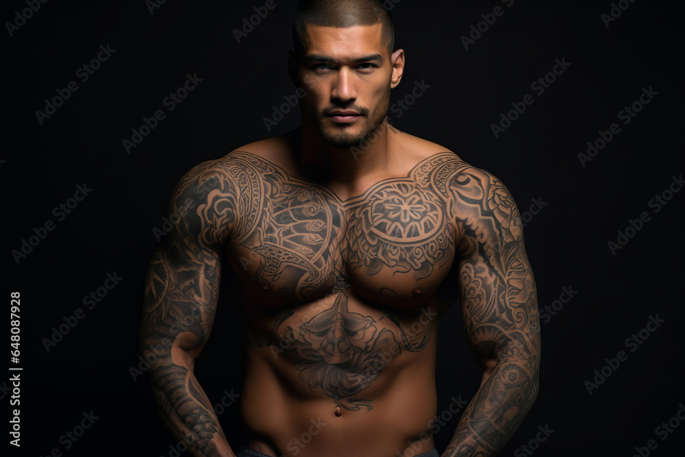 Confident man with muscular body tattooed on black background. Confident man with muscular body tattooed on black background.