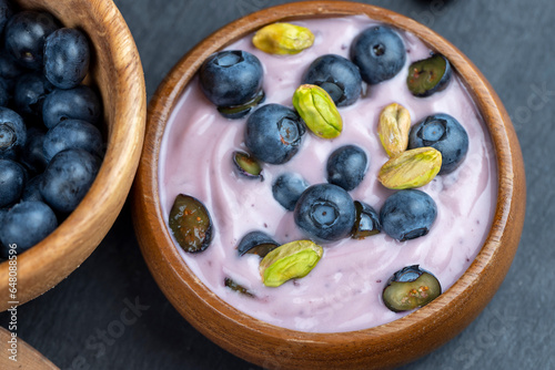 fresh blueberry-flavored yogurt with ripe blueberries and pistachios photo
