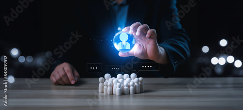 Businessman hold circle of network structure HR - Human resources with woodendoll. Business leadership concept. Management and recruitment. Social network. Different people. photo