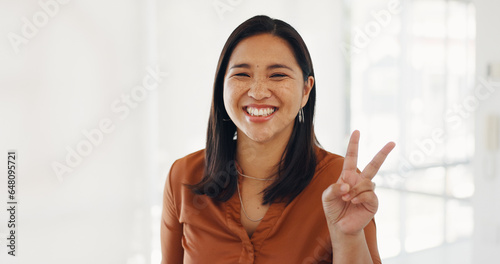 Business, portrait and happy woman with peace, hand or gesture with positive attitude in office. Face, smile and female manager with v, fingers or thank you, support or emoji, cool or expression