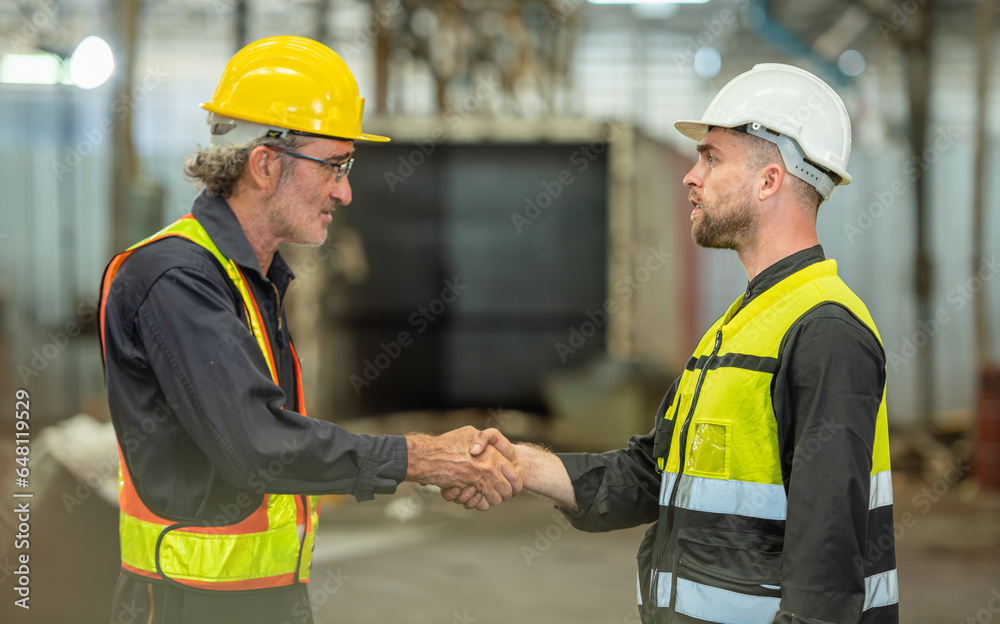 greeting by handshake touch fist and elbow of two engineer supervisor partnership in old factory. foreman greeting friend for good friendship colleague laborer in teamwork factory. greeting by handshake touch fist and elbow of two engineer supervisor partnership in old factory. foreman greeting friend for good friendship colleague laborer in teamwork factory.