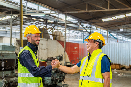 greeting by handshake touch fist and elbow of two engineer supervisor partnership in old factory. foreman greeting friend for good friendship colleague laborer in teamwork factory.