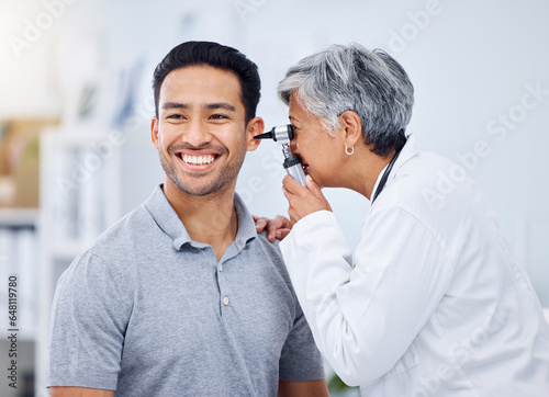 Doctor, patient or ear check for healthcare or wellness at hospital with otolaryngology specialist. Man, smile or senior physician woman with otoscope test for hearing problem or medical consultation