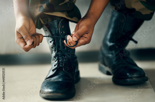 Hands tie shoes, closeup and soldier in army getting ready to start war, battle or fight. Boots, man tying laces in military and veteran preparing gear for training, exercise and workout to travel