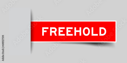 Red color square label sticker with word freehold that inserted in gray background