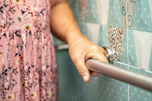 Asian elderly woman patient use toilet bathroom handle security in nursing hospital, healthy strong medical concept.