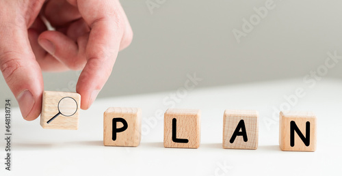 Fototapeta Naklejka Na Ścianę i Meble -  Businesswoman hand holding wooden cube with PLAN text on table background. Goals, success, strategy, solution and business concepts