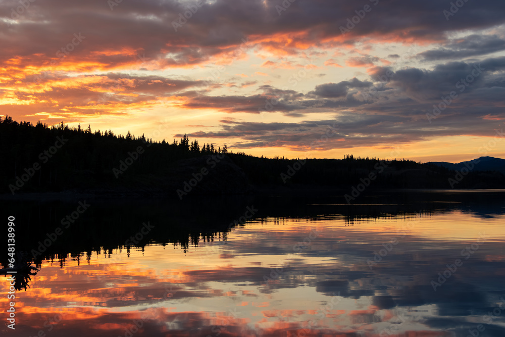 impressive sunset at lake laberge in Yukon Territory, Canada, reflection of epic colourful clouds