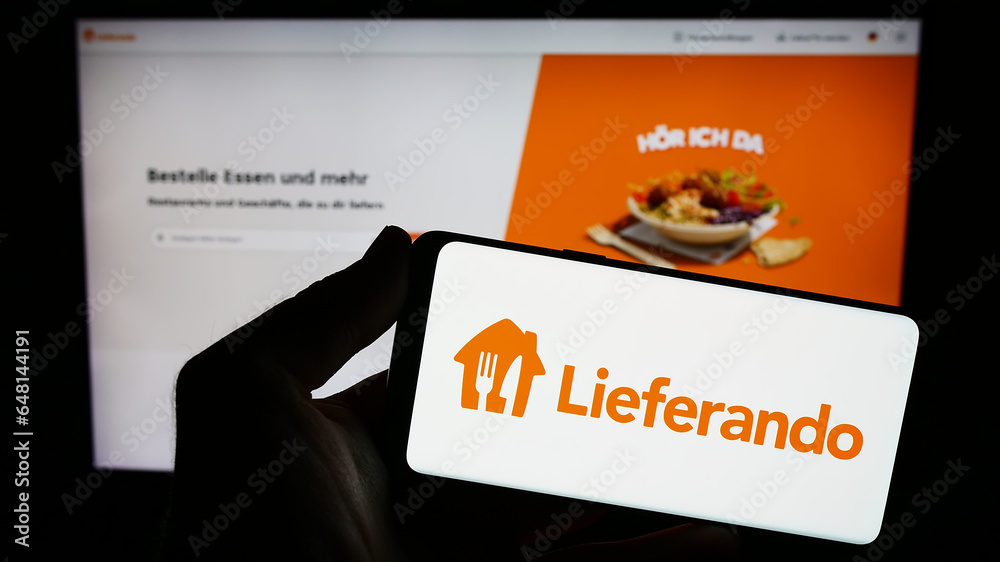 Stuttgart, Germany 09102023 Person holding smartphone with logo of German food delivery