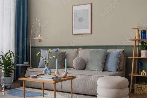 Stampa su tela Aesthetic composition of cozy living room interior with mock up poster frame, modular sofa, blue pillows, wooden coffee table, patterned rug, curtain and personal accessories