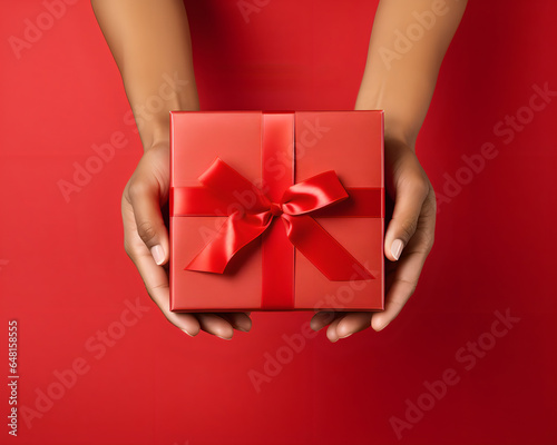 a red gift isolated on a red background, merry christmas concept