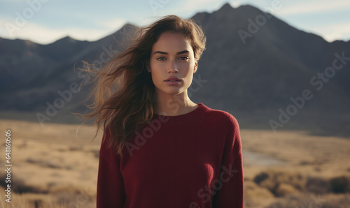 A Captivating Fashion Portrait of a Beautiful Woman, Radiant in a Red Sweatshirt, Embracing the Majestic Mountains, Captured on Timeless Film © Stefan