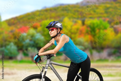 Cycling, young fitness happy woman in park