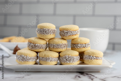 Bilde på lerret Homemade cornstarch alfajores filled with dulce de leche with coconut and cup of