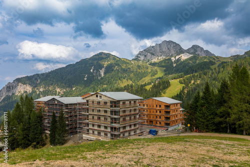 Baustelle für neue Ferienunterkünfte in den österreichischen Alpen für Skitouristen und Sommerurlauber, direkt neben dem Skipisten. photo
