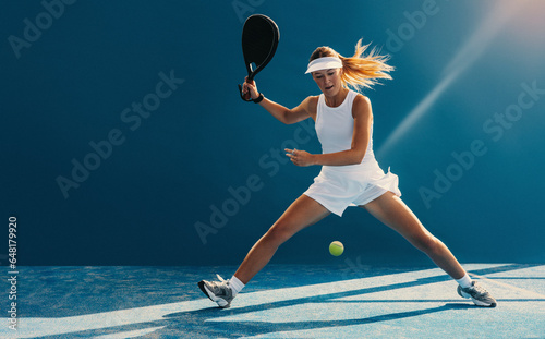 Female padel player in action on the court photo