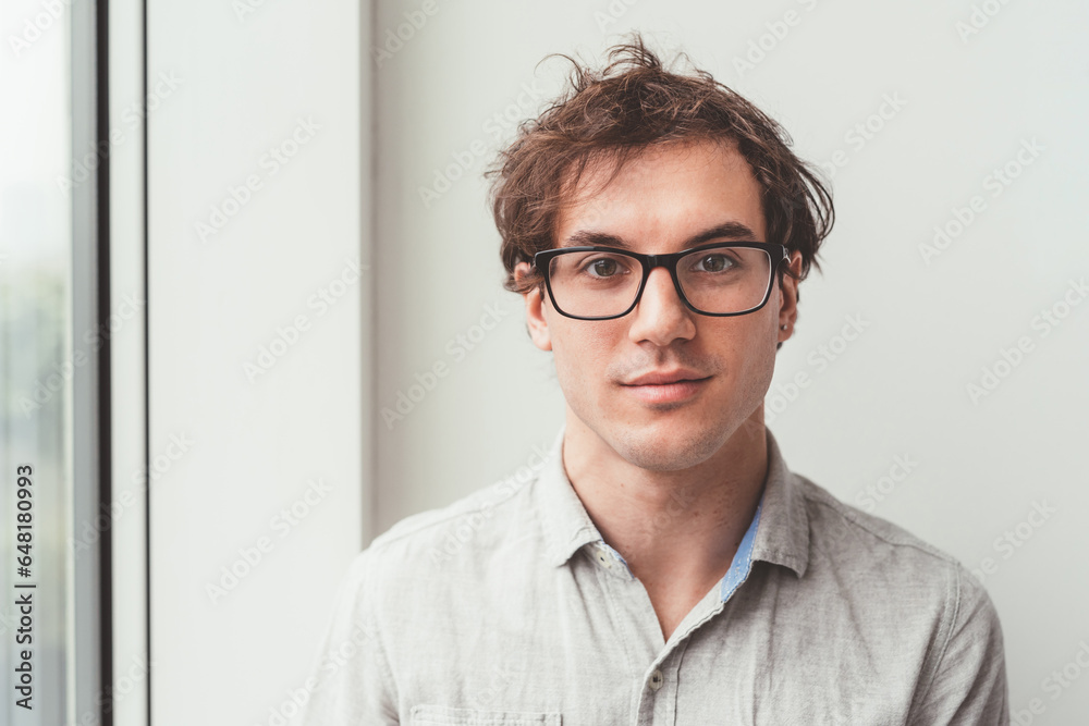 Portrait of young beautiful serene contemporary business man looking camera Portrait of young beautiful serene contemporary business man looking camera