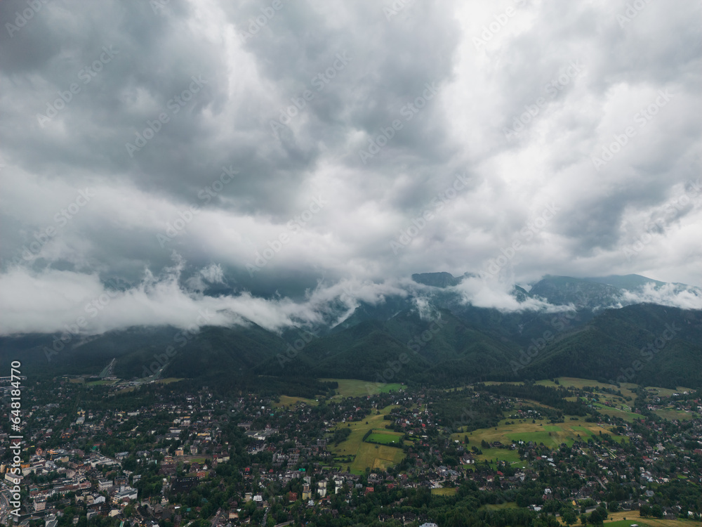 Drone view of the Polish city of Zakopane and the Tatra mountains, the sky is covered with clouds, cloudy weather.