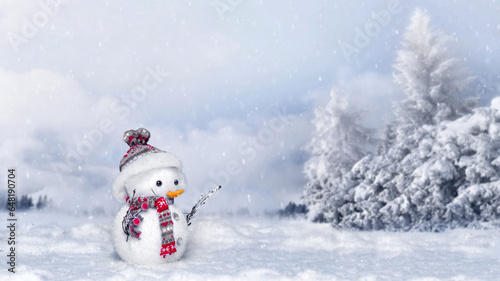 Festive background with a beautiful snowman on the background of a winter snowy forest.