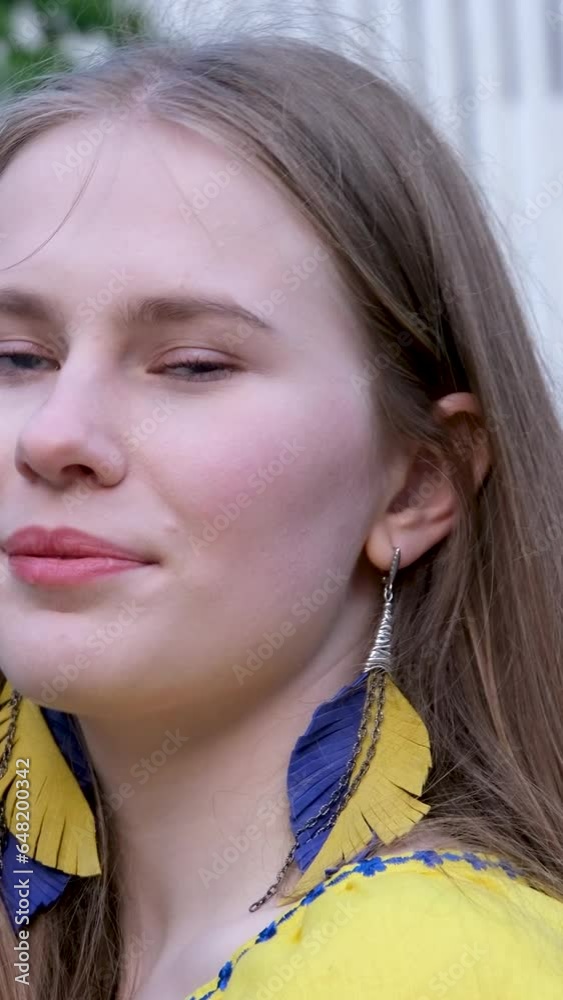 young beautiful woman, young girl in big city in yellow embroidered shirt, embroidered blouse, long brown hair, smile feather earrings, yellow and blue colors in clothes, Ukrainian national costume young beautiful woman, young girl in big city in yellow embroidered shirt, embroidered blouse, long brown hair, smile feather earrings, yellow and blue colors in clothes, Ukrainian national costume