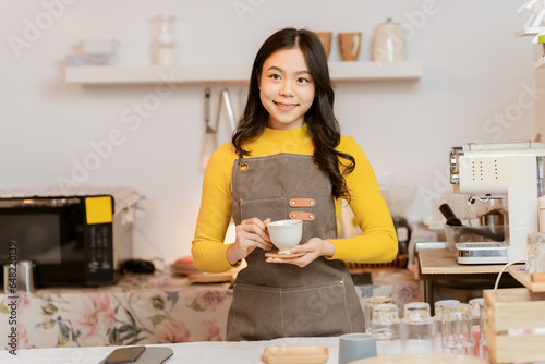 Small business owner, successful businesswoman, beautiful woman standing in coffee shop Portrait of a tanned Asian woman, barista, cafe, business concept owner, seller, SME