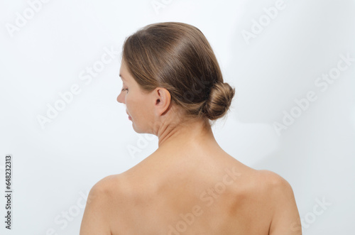 Woman hair is gathered into a ball. Women hairstyle