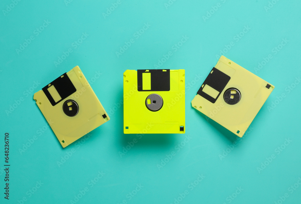 Yellow floppy disks on a blue background. Retro technology. Top view Yellow floppy disks on a blue background. Retro technology. Top view