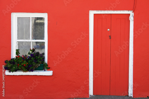 A Red Painted House With Flower Box In The Window; Eyeries, County Cork, Ireland photo