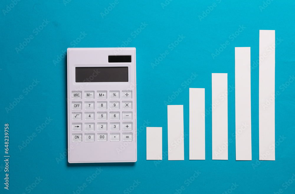 Calculator with graph columns on a blue background. Economy, business concept Calculator with graph columns on a blue background. Economy, business concept