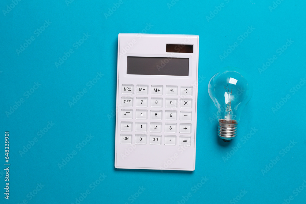 Calculator and light bulb on a blue background. Creative idea Calculator and light bulb on a blue background. Creative idea