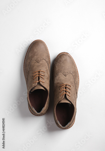 Stylish leather brogue shoes on a white background. Men's footwear. Top view